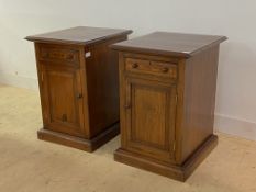 A pair of rustic oak pedestal cupboards of Georgian design, the moulded tops over drawer and