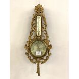 A 20th century gilt composition aneroid barometer and thermometer in the Rococo taste H54cm