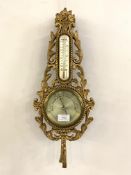 A 20th century gilt composition aneroid barometer and thermometer in the Rococo taste H54cm