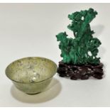 A modern Chinese jadeite bowl of mottled spinach and celadon colour, (5cm x 10cm) and a Chinese