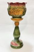 A Victorian style pottery moulded jardiniere and stand with flared rim, decorated with sea serpent