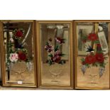 A set of three rectangular bevelled glass wall mirrors with etched vase and floral and bird studies,
