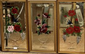 A set of three rectangular bevelled glass wall mirrors with etched vase and floral and bird studies,