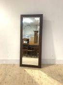 A Contemporary wall hanging mirror, the leather covered frame enclosing a bevelled plate, 141cm x