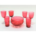 A cranberry glass circular rose bowl raised on crimped stand (8cm x 13cm), a pair of spiral