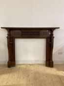 An Edwardian carved walnut fire surround, the moulded mantelpiece over floral carved frieze and
