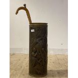 An embossed brass stick stand of cylindrical form (H65cm) together with an ebonised malacca cane