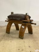 A camel stool, with leather seat cushion, L60cm