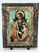 A Croatian treen panel with painted image of Madonna and infant Jesus, in plaster moulded framed