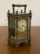 A late 19th/ early 20th century brass four glass carriage time piece clock, the case with swing