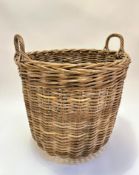 A handmade wicker two handled log basket of tapered cylinder design (53cm x 56cm), note please see