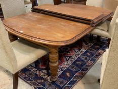 A Victorian walnut extending dining table, with two leaves, raised on turned supports, H67cm,
