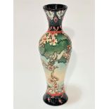 A modern Moorcroft Stoke on Trent baluster vase decorated with cherry blossom design, with blue leaf