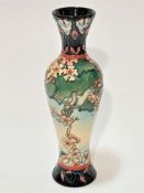 A modern Moorcroft Stoke on Trent baluster vase decorated with cherry blossom design, with blue leaf