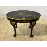 An early 20th century ebonised low table, the oval top with lacquered chinoiserie decoration, raised