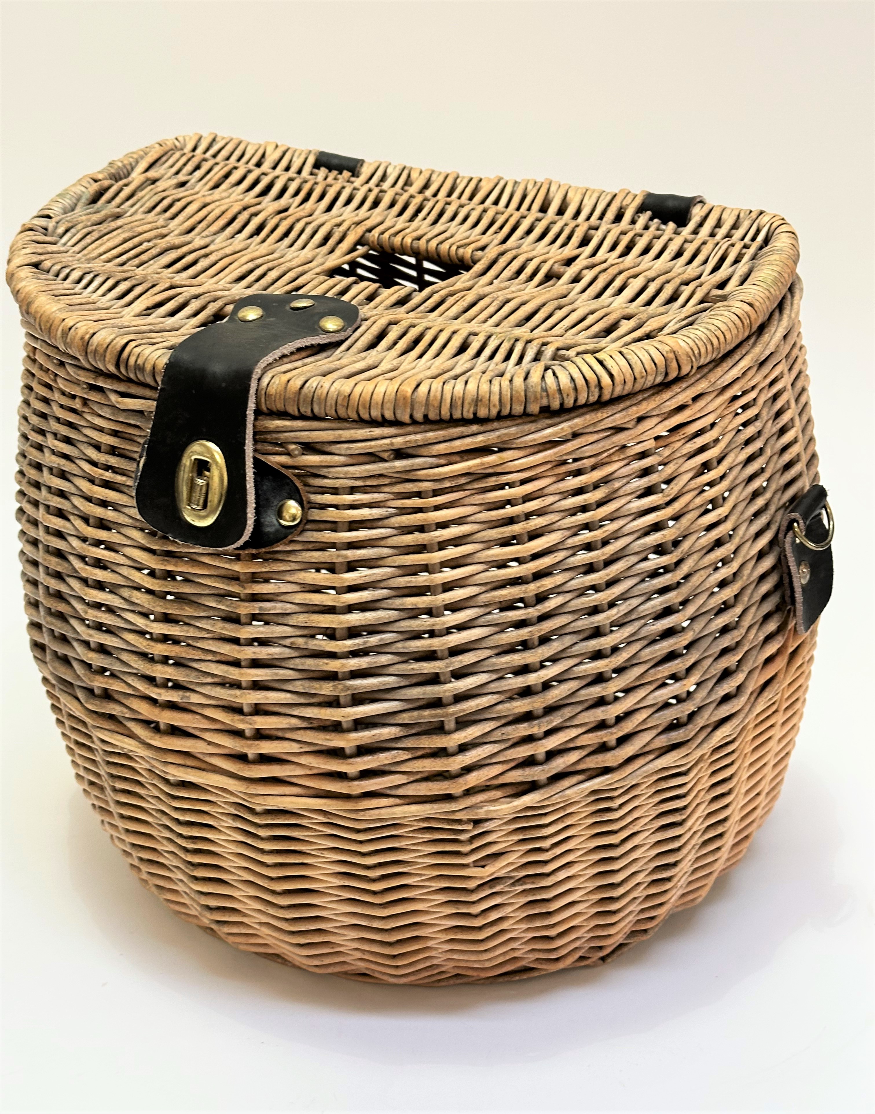A handmade wicker bow front fishing creel with leather strap mounts, (31cm x 34cm)