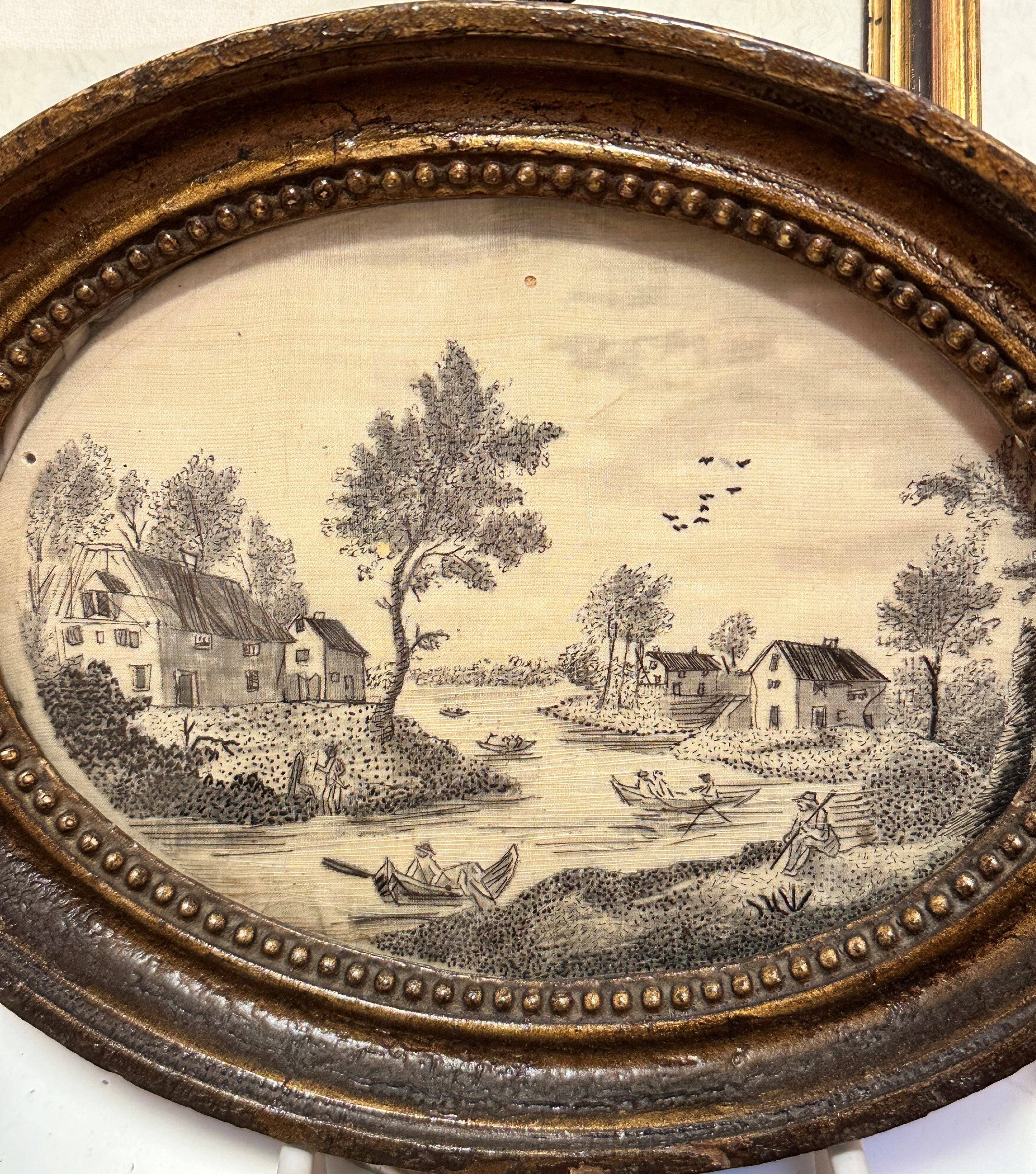 A pair of 19thc oval silk printed panels depicting Continental River Scenes with Figures on Boats, - Image 3 of 3