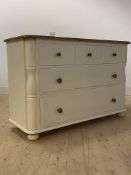 An oak and cream painted chest, the moulded top over three short and two long drawers, raised on bun