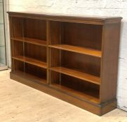 A Mahogany open bookcase, second half of the 20th century, the moulded top over four adjustable