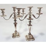 A pair of Victorian style Sheffield plated three branch candelabra with knop and circular tapered
