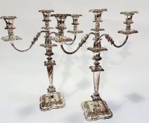 A pair of Victorian style Sheffield plated three branch candelabra with knop and circular tapered