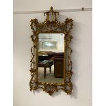 A large Italian giltwood and composition framed wall hanging mirror, the frame with pagoda
