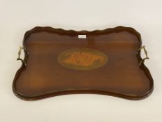 An Edwardian mahogany drinks tray of serpentine outline, with brass handle to each end, scalloped