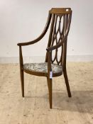 An Edwardian inlaid mahogany high back occasional chair, with openwork back, swept arms, shaped seat