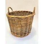 A handmade wicker two handled log basket (46cm x 55cm)