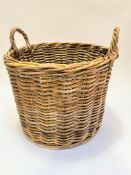 A handmade wicker two handled log basket (46cm x 55cm)