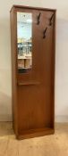 A mid century teak hall cupboard, the front with mirror (A/F) three hooks and an open shelf, with