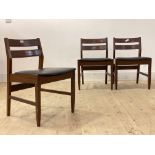 A set of five mid century teak dining chairs, with vinyl upholstered seats, raised on square tapered