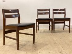 A set of five mid century teak dining chairs, with vinyl upholstered seats, raised on square tapered