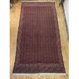 An Anatolian hand woven kilim, the red field with repeating lozenge motif and bordered, 416cm x