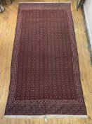 An Anatolian hand woven kilim, the red field with repeating lozenge motif and bordered, 416cm x