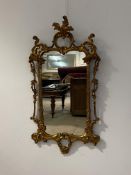 An Italian giltwood and composition framed wall mirror, the frame with scrolling acanthus