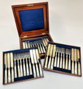 An Edwardian mahogany canteen containing three trays with six mother of pearl handled engraved fruit