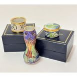 A Moorcroft enamelled on copper shaped baluster shaped miniature vase decorated with stylised flower