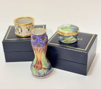 A Moorcroft enamelled on copper shaped baluster shaped miniature vase decorated with stylised flower