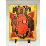 A modern Russian icon depicting Christ with Saints and angels, decorated with gilt reserve, on