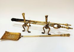 A collection of brass fire companions comprising iron, guards, shovel, poker etc.