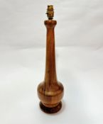 A mid century teak baluster lamp raised on circular moulded base, (49cm x 14cm)