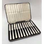 A set of twelve 1920/1930s Sheffield silver handled tea knives with steel blades, retailed by