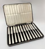 A set of twelve 1920/1930s Sheffield silver handled tea knives with steel blades, retailed by