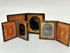 A pair of 19thc embossed leather cases containing early photographs of a young girl with bonnet
