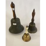 A large Victorian brass school bell with turned handle (H38cm) together with two other bells, one