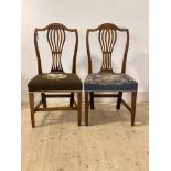 A pair of late Georgian mahogany chairs, with shaped crest rail over pierced splat back,