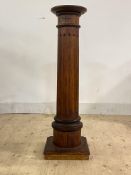 A stained pine column of architechtural form, with square top on a fluted shaft and square base,