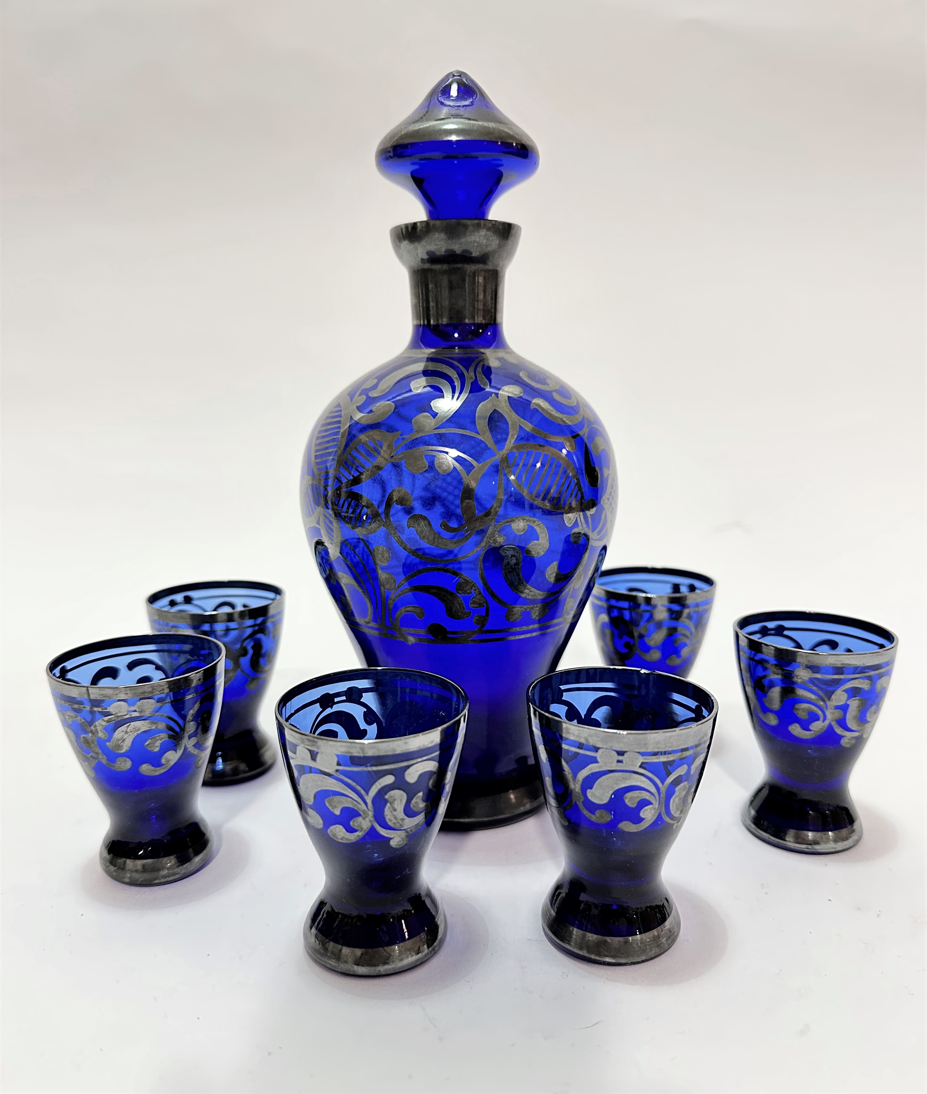 An Italian blue glass seven piece set of glassware including a baluster decanter complete with