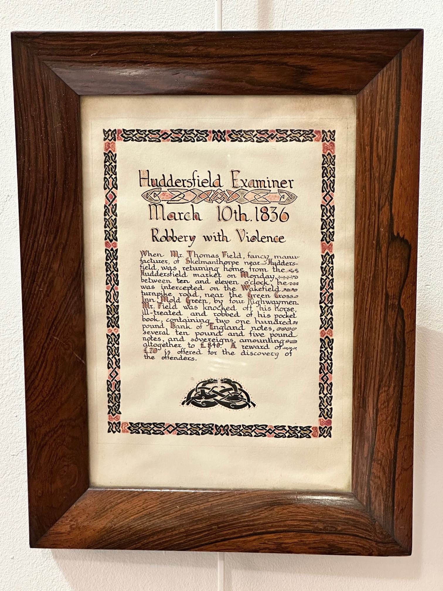 A 19th century rosewood frame containing an illuminated panel "Huddersfield examiner March 10th 1836